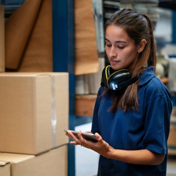 Warehouse worker updating the stock on mobile app