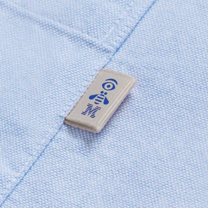 IBM rebus logo in blue on white tag sewn on woven shirt pocket