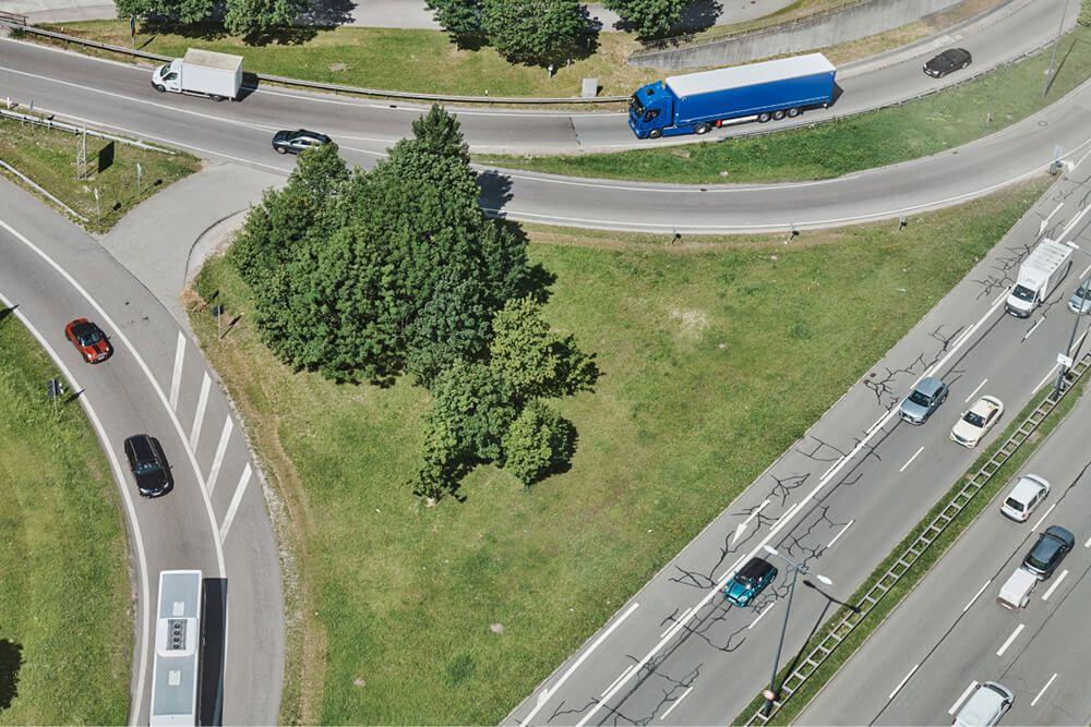 aerial view of highway intersection with cars and trucks