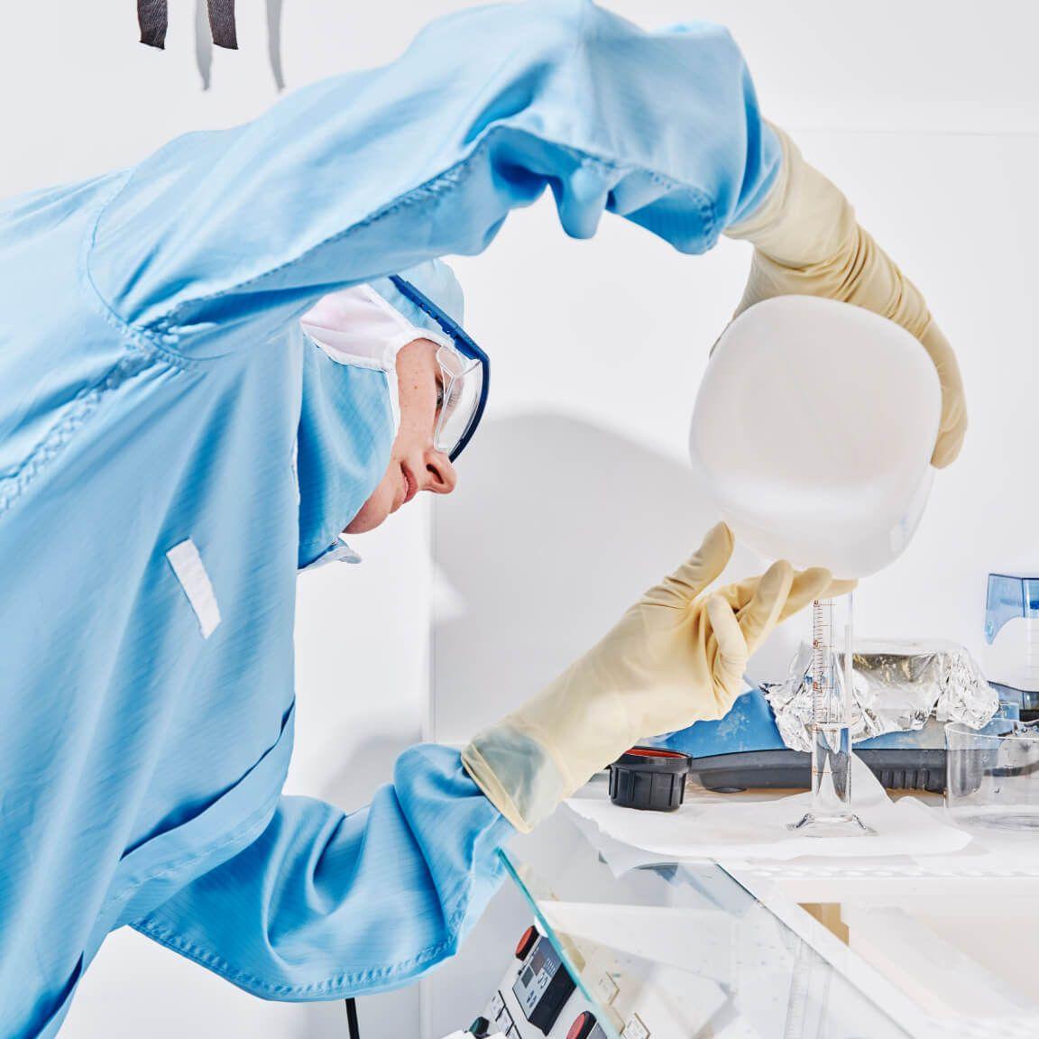 portrait of person in clean room pouring liquid