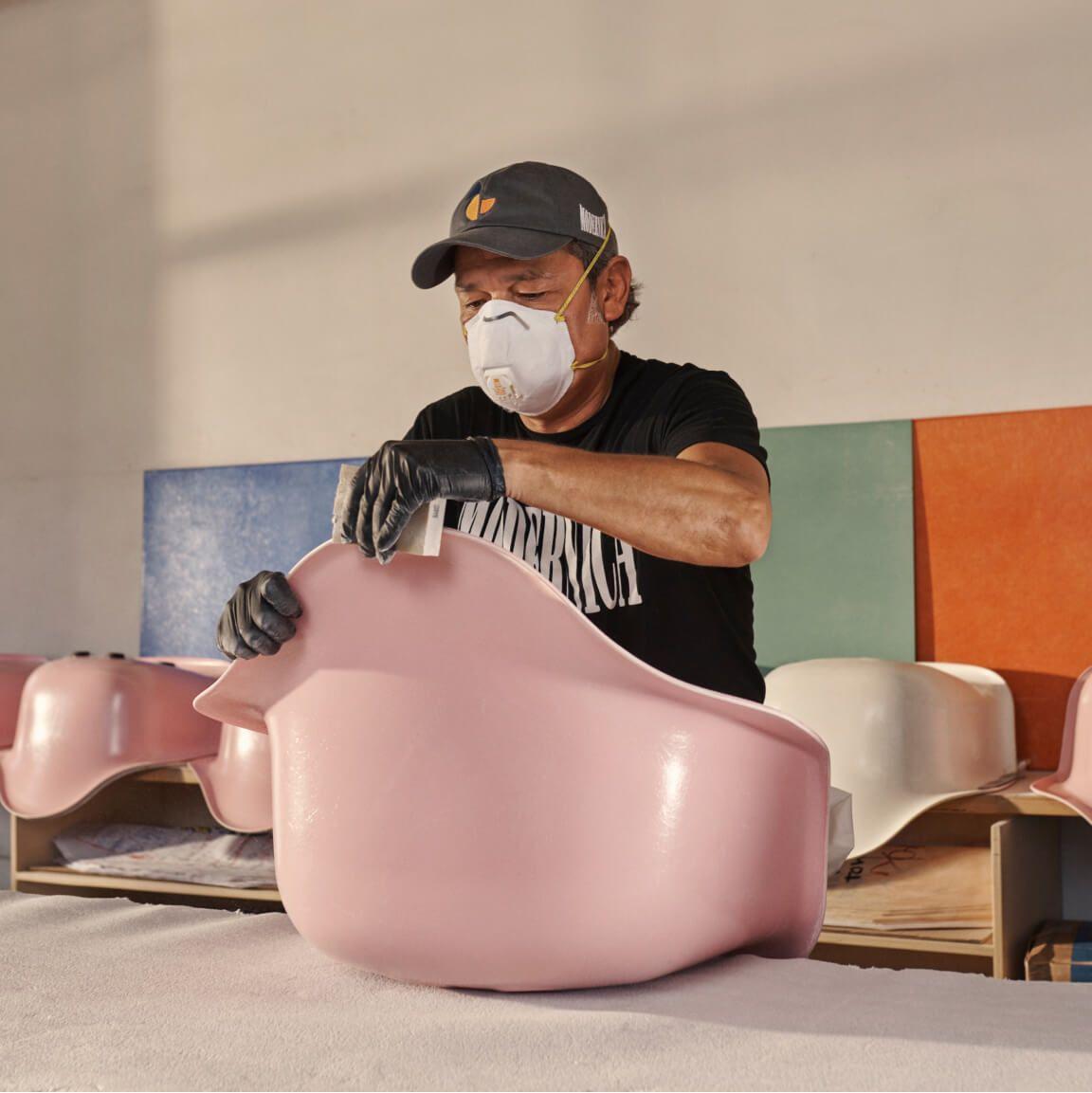 portrait of person  crafting fiberglass chairs