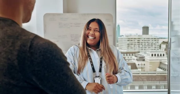 Consultant smiling at partner in modern office