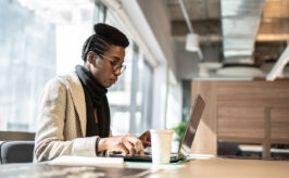 SAP Consultant Skills - African American woman sitting at a desk in office environment