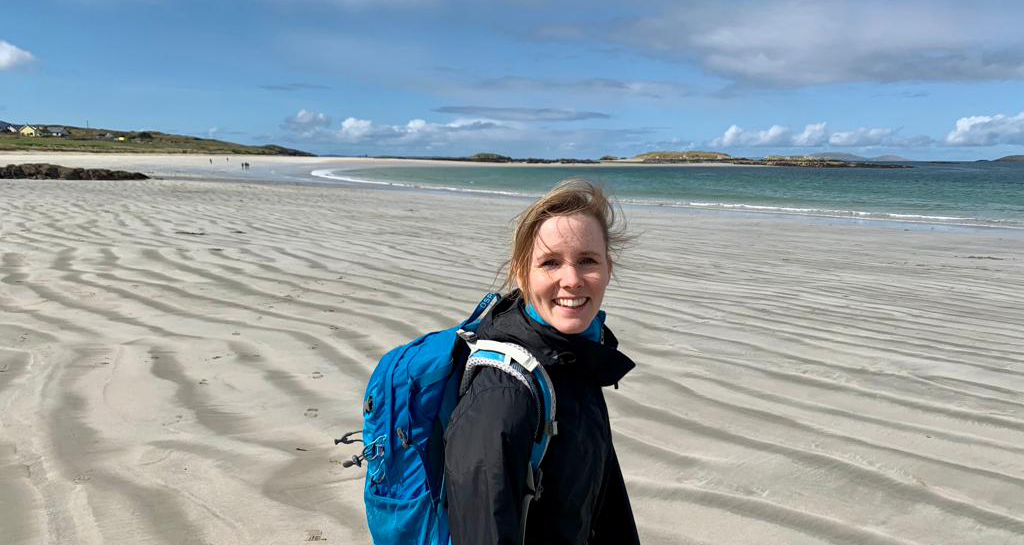IBM Tech Sales female employee pictured while hiking on a beach