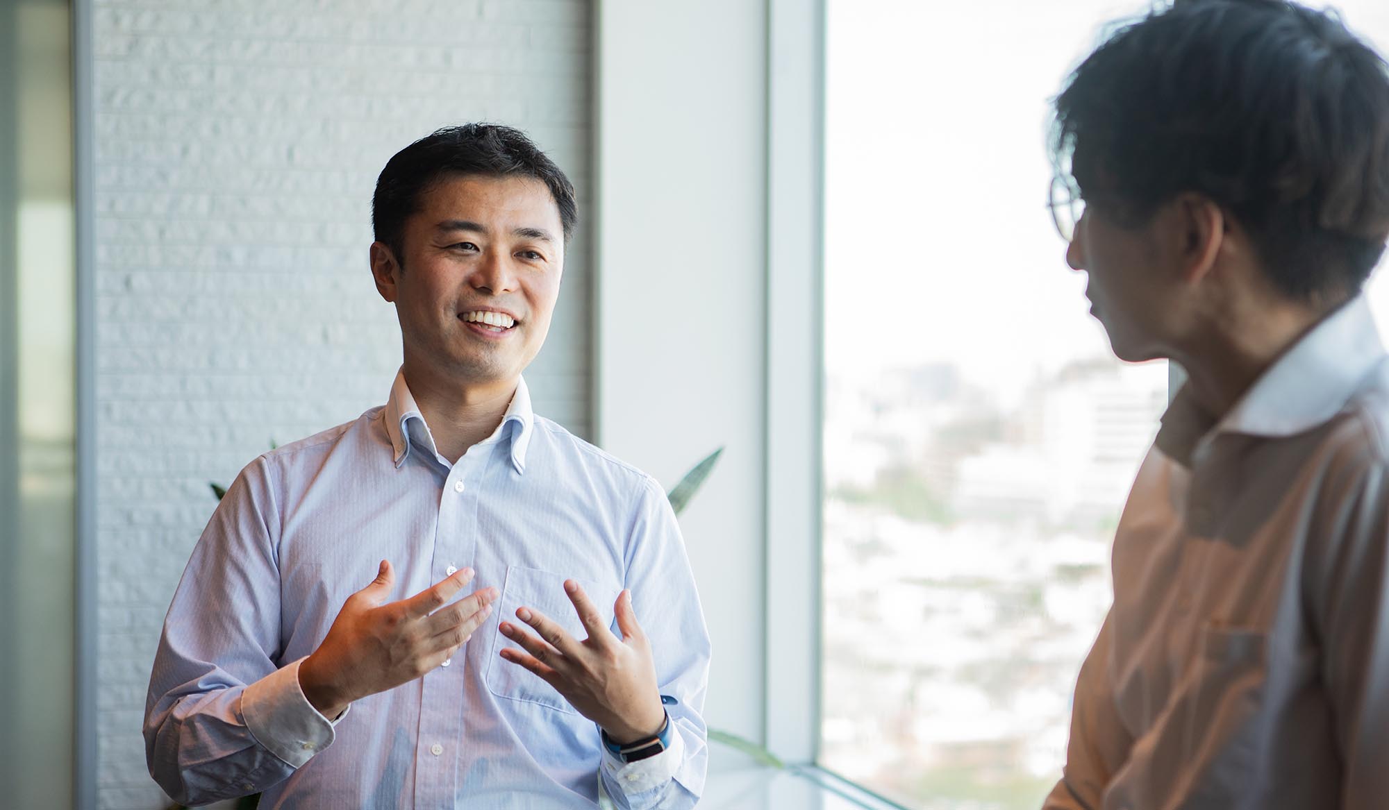 A man talking to a colleague during a break