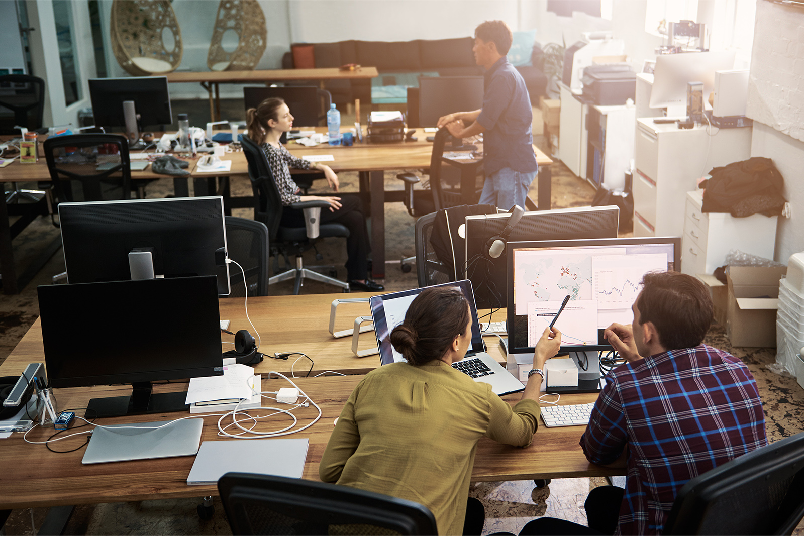 Two coworkers discussing around a conference table