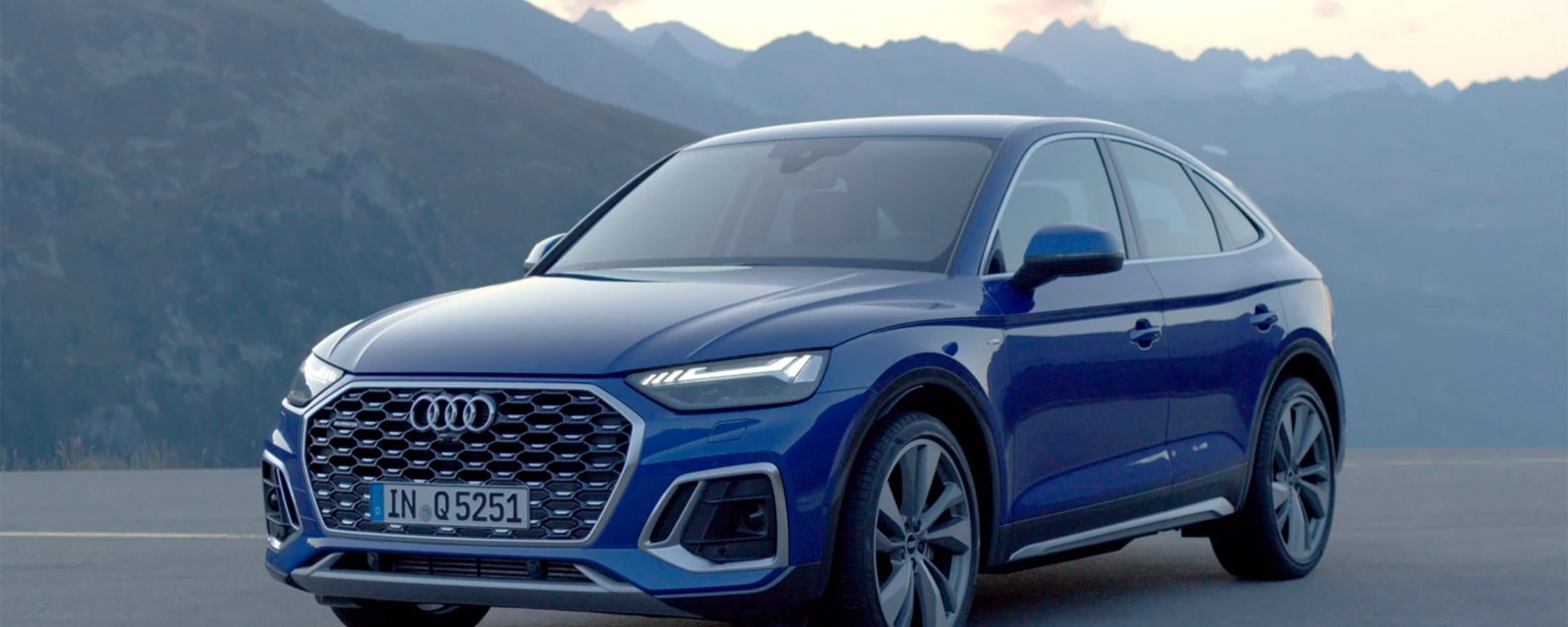 Blue Audi Q5 Sportback displayed against mountain background