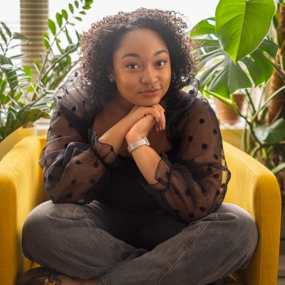 Employee sitting on a couch and smiling in an IBM Office