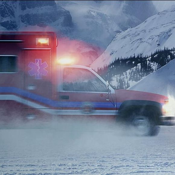 Ambulance driving through the snow