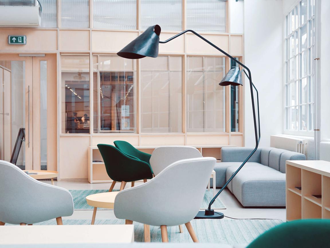 Bright interior with light gray and dark green chairs