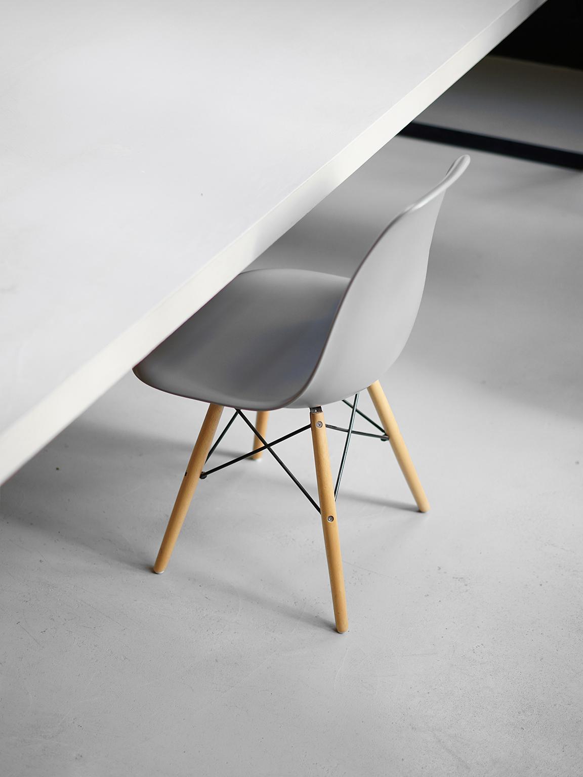 Close-up of gray chair on white table