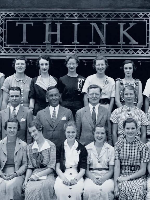 historical photo of people below Think® sign