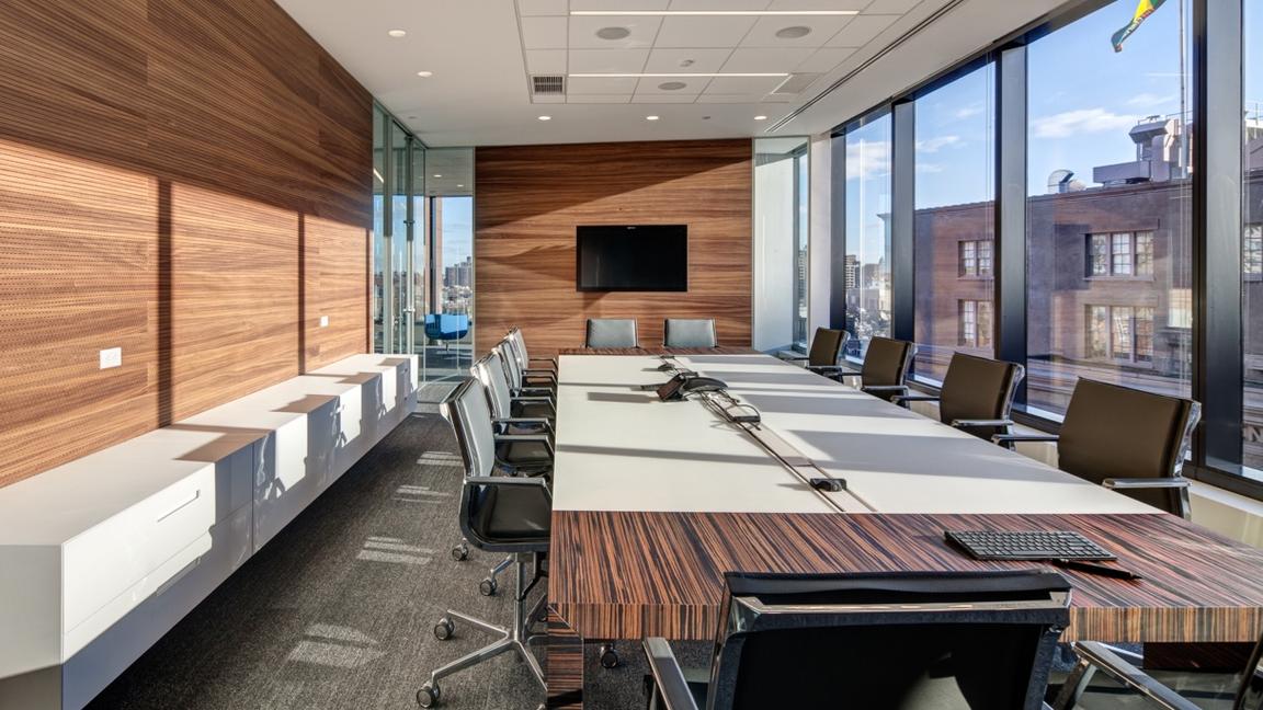 wood finish palette echoed on walls and conference table