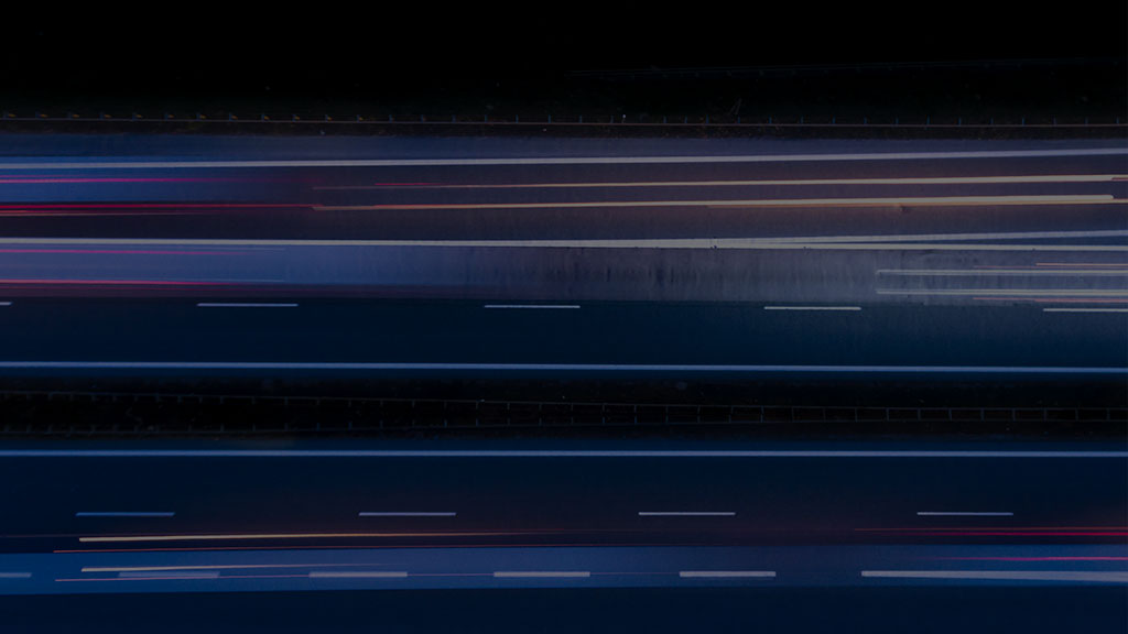 Time-lapse overhead photo of highway at night