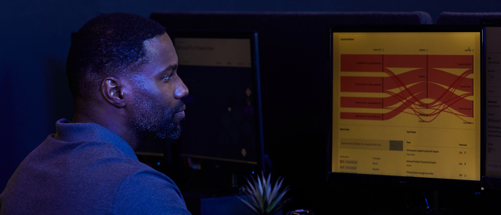 Man looking at computer screen showing a graph
